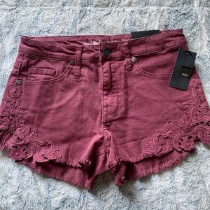 Rose colored high rise jean shorts. Size two.